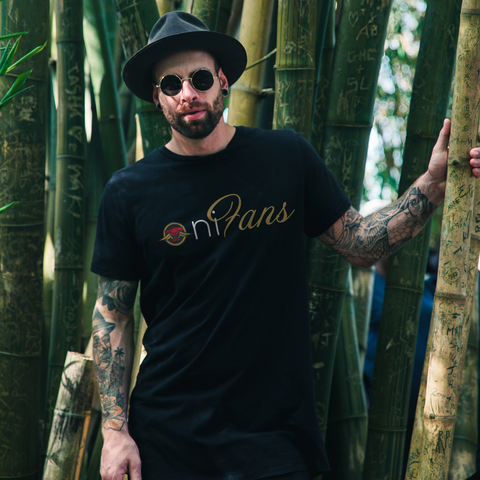 white man in korean style sunglasses with tattoos sleeves and with black gauges in an oni fans tshirt by oni threads standing in a bamboo forest 