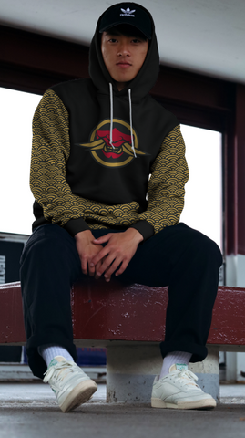 Asian male in adidas hat and Oni Threads Seigaiha Samurai Hoodie wearing black jeans and white shoes in an urban setting