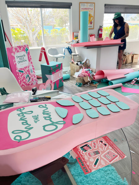 Kit, a craft-based-designer builds some colourful giant oversized props in a kitchen