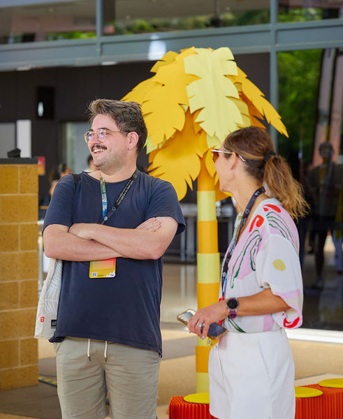 Giant yellow paper prop behind conference attendees at Pinterest's Cannes In Cairns Conference