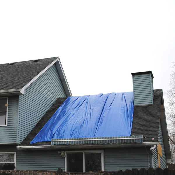 Blue poly tarp used to cover a roof