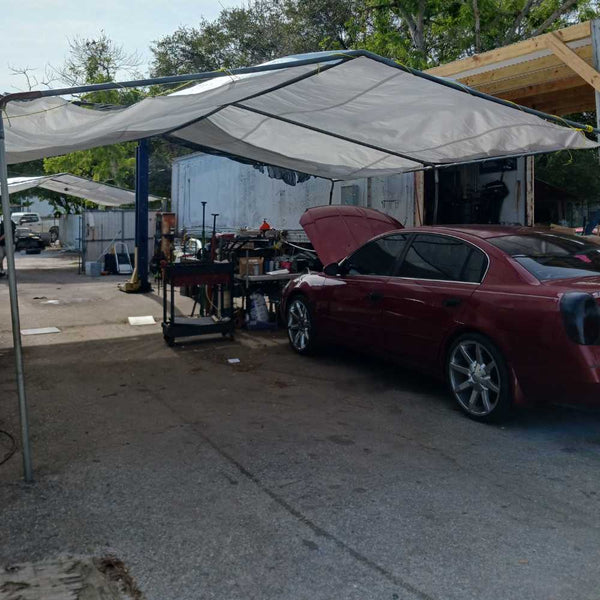 Mechanic used this 10 mil heavy duty white poly tarp as canopy cover for shade and weather protection while they work on cars