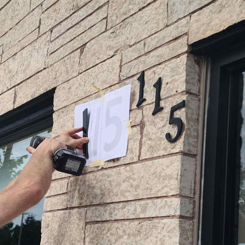 using a template for easy house number installation on brick