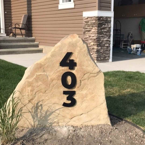 front yard landscaping ideas that include an house number sign on a rock