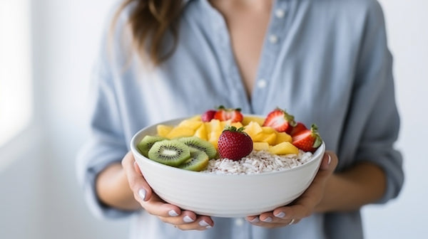 a woman holding a bowl of healthy food