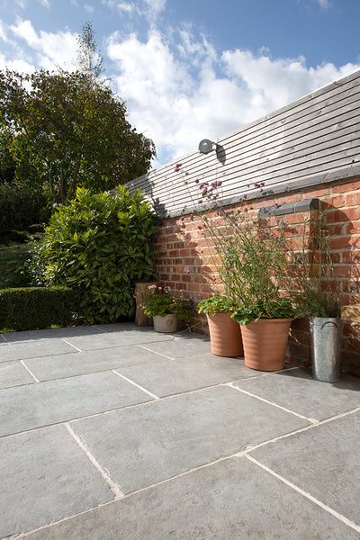 patio-flooring-trends-worn-grey-antiqued-limestone-paving