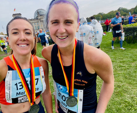 Ally and a female friend with medals around their neck