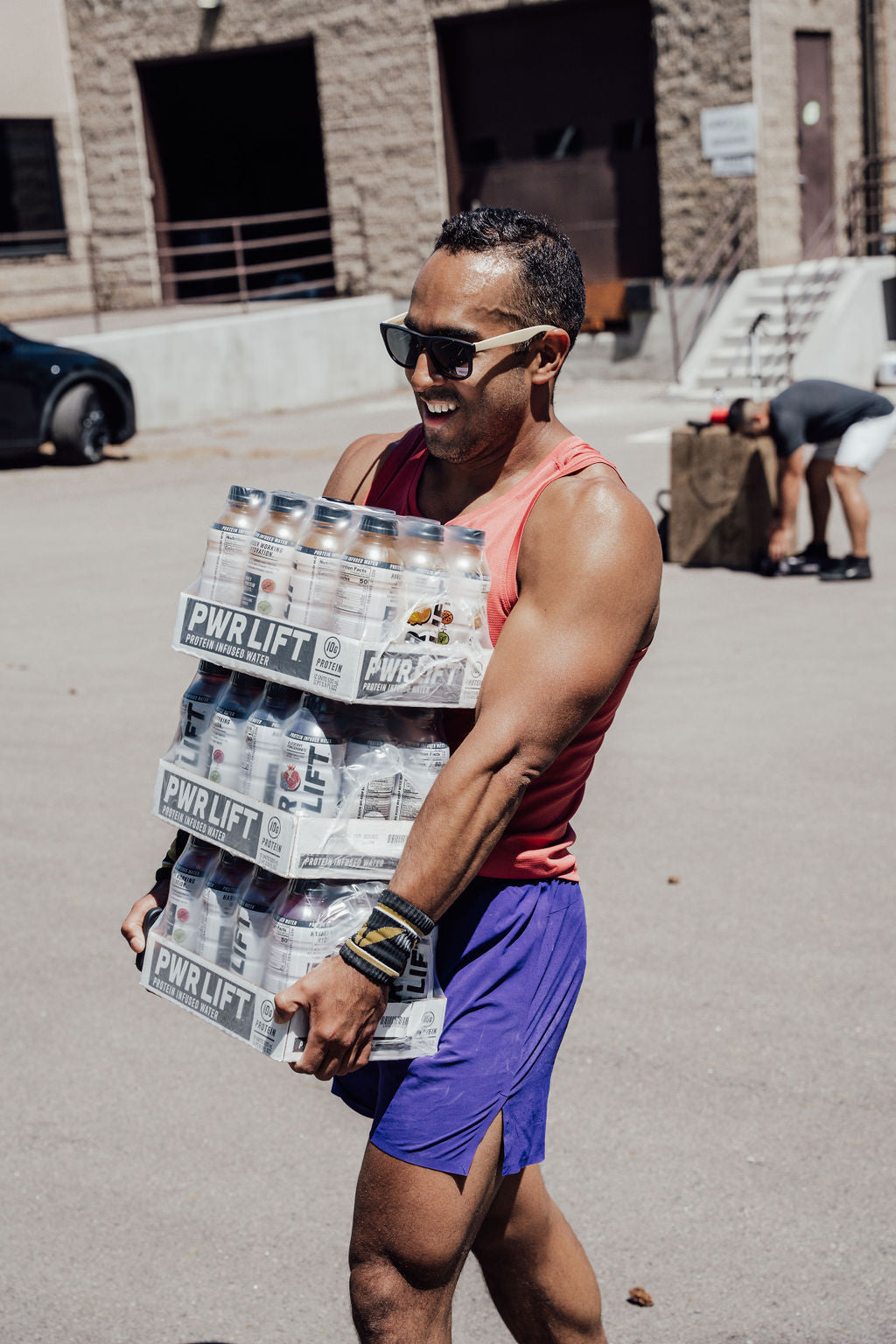 A man carrying a case of PWR lift