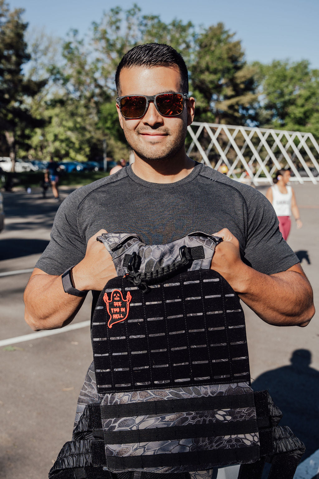 A man with shades smiling at the camera