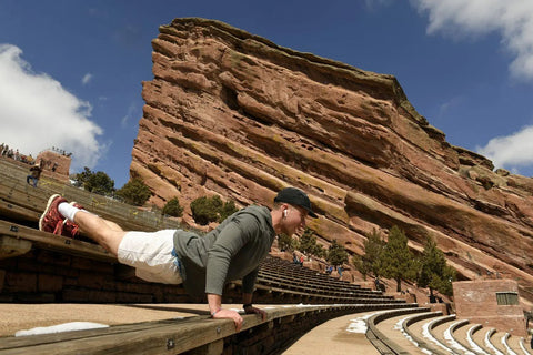 a man working out beside sandstones