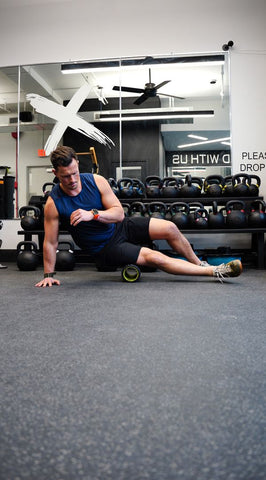 A man doing foam rolling from the side 