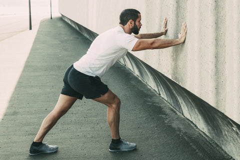 Man doing wall stretch