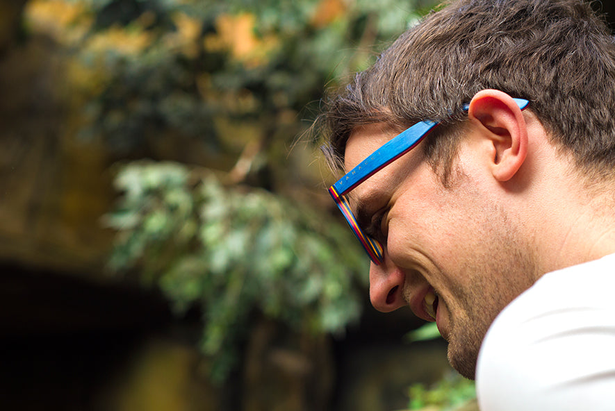 Vanacci mens wooden sunglasses in blue, worn on a man looking away