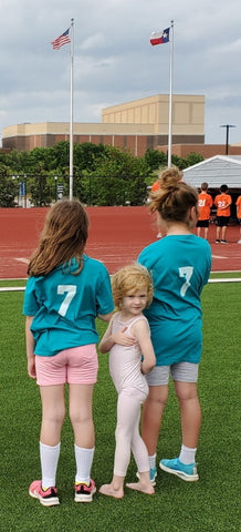 Girls at youth track meet saying the pledge