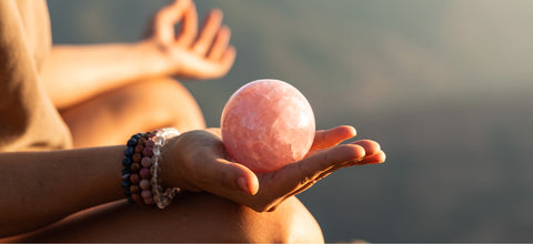 rose quartz crystal sphere meditation at sunset in Sedona Arizona