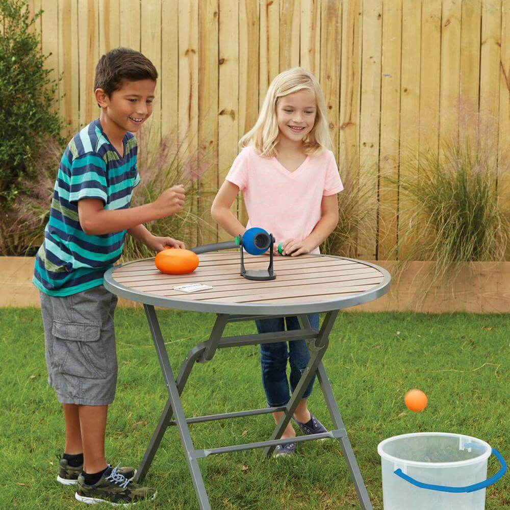 boy and girl in backyard, smiling and playing Smash Pong Game