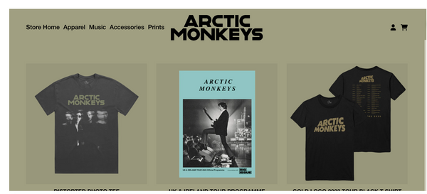 Arctic Monkeys t-shirts and poster on a khaki green background.