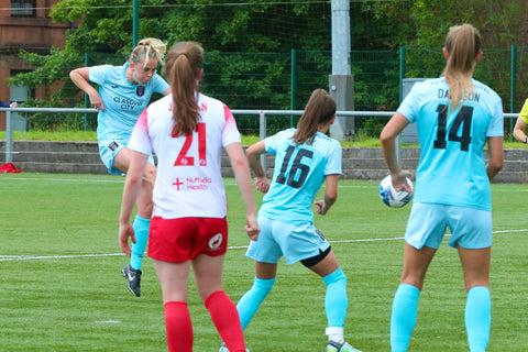 Claire Walsh (far left) volleys the ball towards goal past Jordan (21), Kozak (16) and Davidson (14)