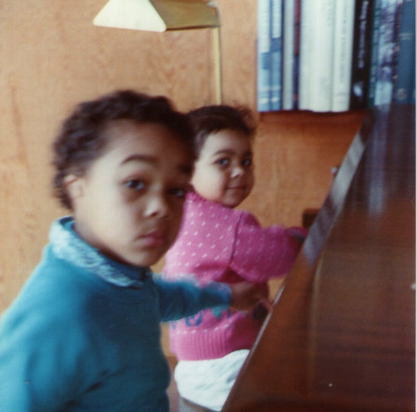 A young Alexander Rameses Taite playing piano