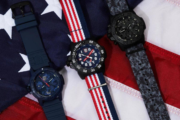 Three Luminox x Volition America watches on an American Flag background