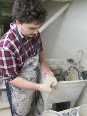 Everette finely sanding one of our plaster castings of a foot.
