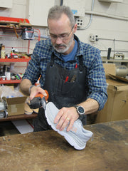 Ralph Baker Jr. preparing a shoe for a build-up.