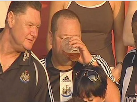 a supporter of Newcastle drinking a beer