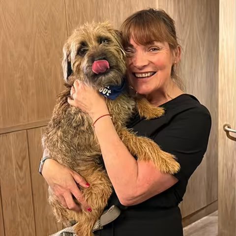 Lorraine Kelly holding her dog at dog party
