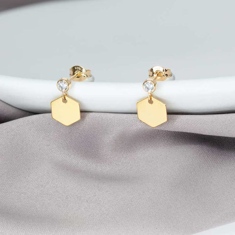 geometric gold cz honeycomb stud earrings on the white plate