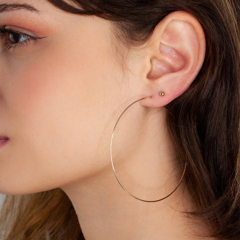 hoop earrings on woman ear