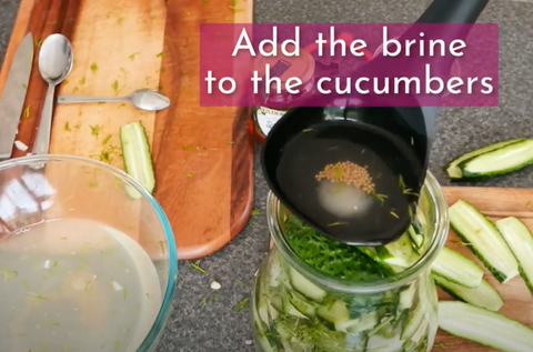 Add brine to the cucumbers