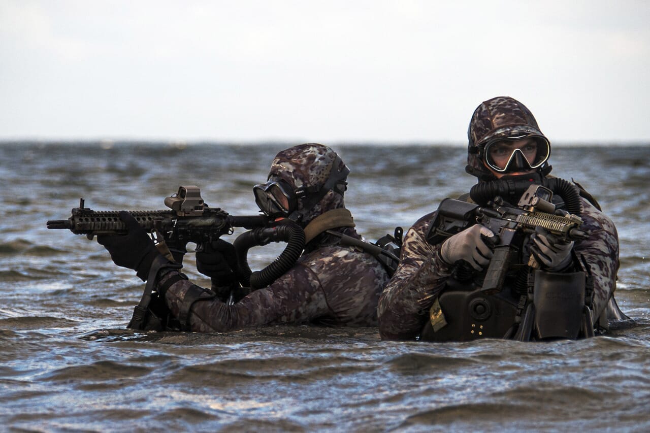Commando fighters, Navy SEALs infantrymen giving emergency help to