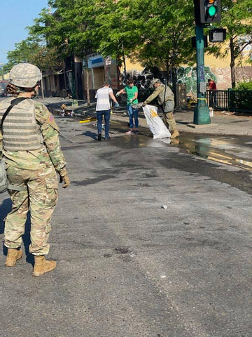 soldiers helping clean up after protest