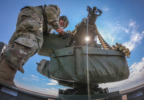 soldier loading m-60 machine gun