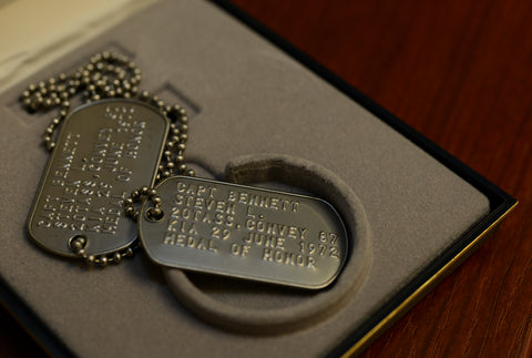 Two modern dog tags on table