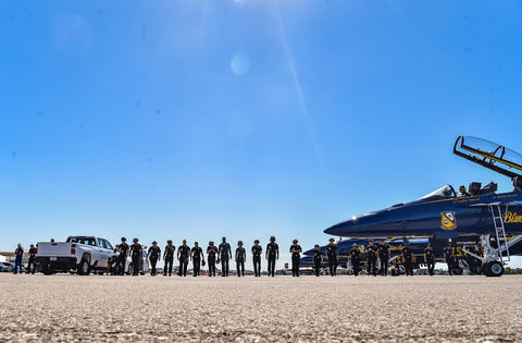 Blue angel jet on the ground surrounded by people