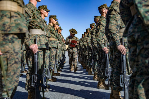 US Marine corps soldiers at attention being inspected by drill sergeant