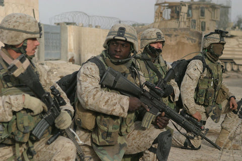 Four US Army special forces operators kneeing in combat gear