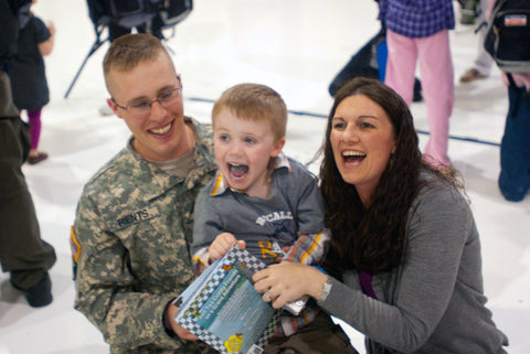 Soldier with wife holding laughing child