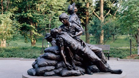 Bronze statue of fallen soldier being held by a woman