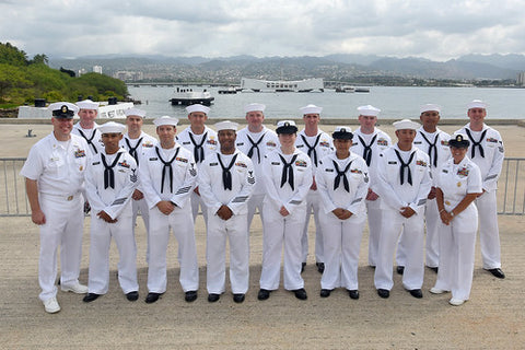 US Navy sailors in uniform posing for group picture