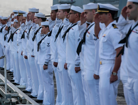 USN sailors in uniform saluting