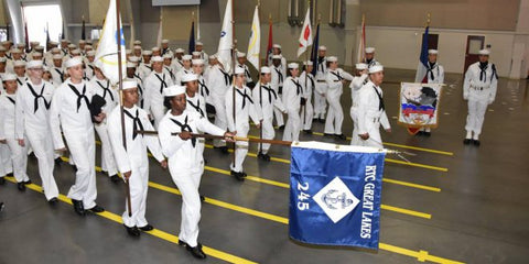 Navy Sailors in full uniform in a graduation ceremony