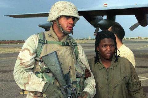 Two soldiers in front of a cargo jet