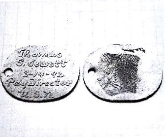 Antique photo of older styled dog tags one with fingerprint on it