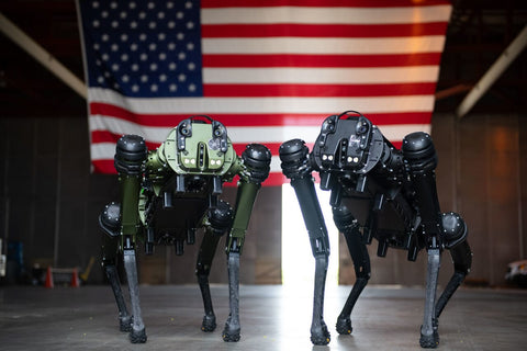 military robot dog in front of flag