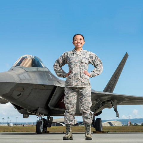 Female soldier in camo uniform in front of USAF jet