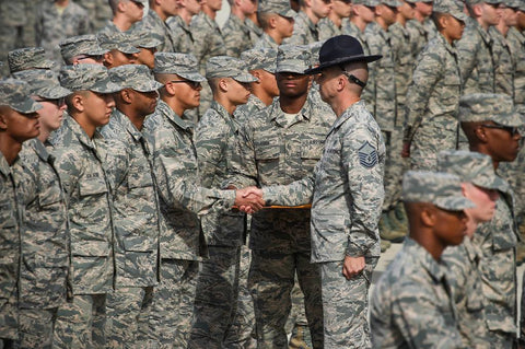 army officer shaking hands with graduating recruits