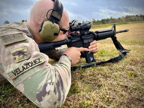 US army solider firing m-4 prone