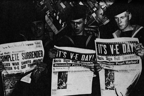 Sailors reading newspaper about VE Day